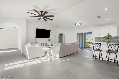 Living room with ceiling fan, light tile patterned