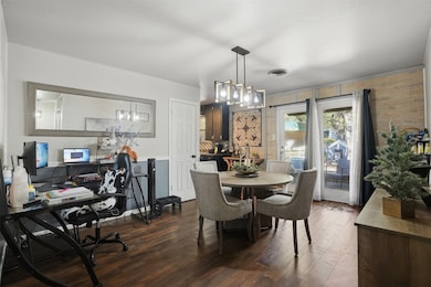 Dining room featuring dark wood-style flooring and an office area