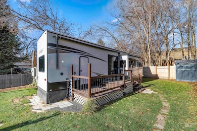 Back of house featuring a fenced backyard, a deck, and stucco siding
