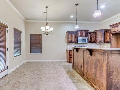 Kitchen featuring backsplash, crown molding, light