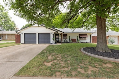 Ranch-style home with an attached garage, a front lawn, and driveway