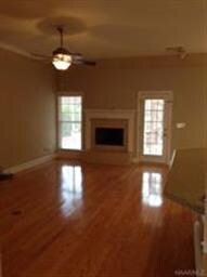 The spacious great room with gleaming floors and g