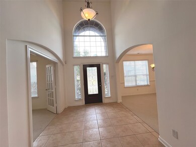 Reception area has high ceiling, Arched transom wi