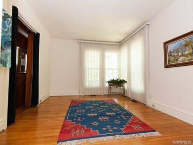 Family room off front hall with tall corner window