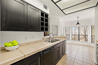 Kitchen with dishwasher, ornamental molding, ligh