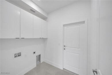 Laundry room featuring cabinet space, hookup for a