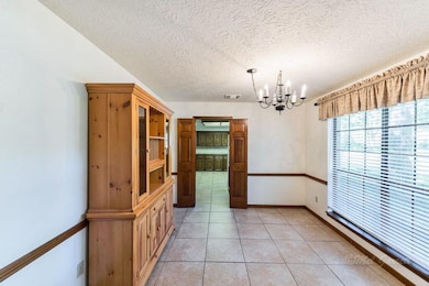FORMAL DINING  ROOM - is located to the right of the foyer and looks onto the lush front yard. Direct access to the kitchen makes this space ideal for holiday entertaining.
