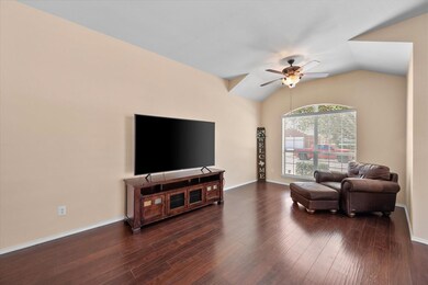Living area featuring baseboards, lofted ceiling, 