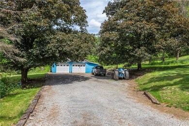 Long driveway leads to the detached garage that ho