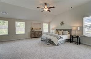 Carpeted bedroom with visible vents, baseboards, vaulted ceiling, and a ceiling fan