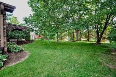 A view of the back yard with lush landscaping and 