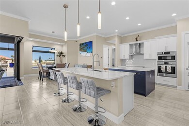 Kitchen with white cabinets, sink, a kitchen islan