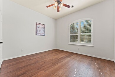 Secondary bedroom on the front of the house with plantation shutters.