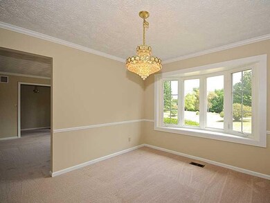 Dining Room. The dining room features a bay window, beautiful chandelier and is open to the living room and kitchen.
