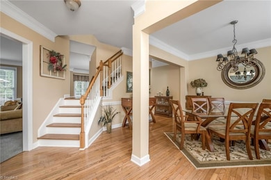 View of stairwell and open dining room area from the front door.