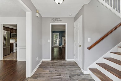 Entryway with stairway and wood finished floors