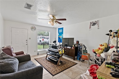 Living area featuring a ceiling fan