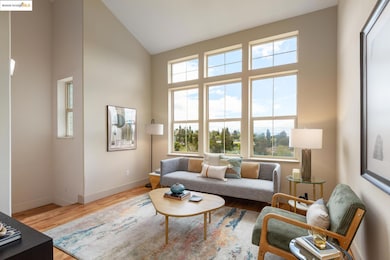 Living area featuring healthy amount of natural light, light wood finished floors, and high vaulted ceiling