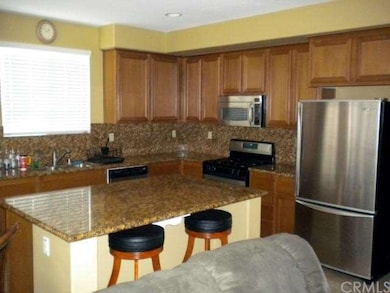 Kitchen features granite counters, breakfast bar, 