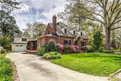 Side view of home.  Notice screen porch and detached garage