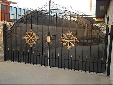 Gated entrance to back yard and a car po