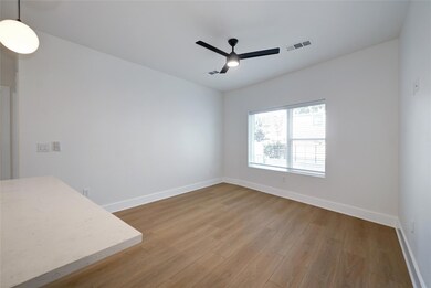 Spare room with a ceiling fan, wood finished floo