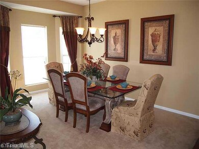 Dining Room. Bay window on side of dininig room.  Neutral paint colors and open to the rest of the house.  Wood floors in the foyer and front hallway and half bath.