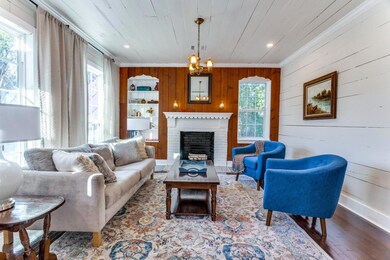 LIVING AREA WITH SHIPLAP WALLS, RESTORED HARDWOOD 