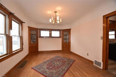 Dining room with wood floors and charming built-in cabinets.