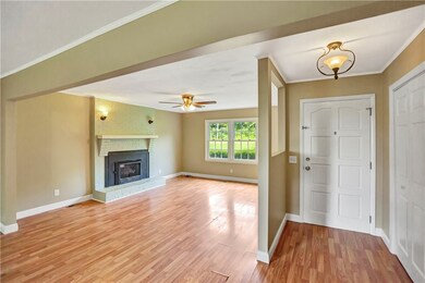 Front door and living room with fireplace