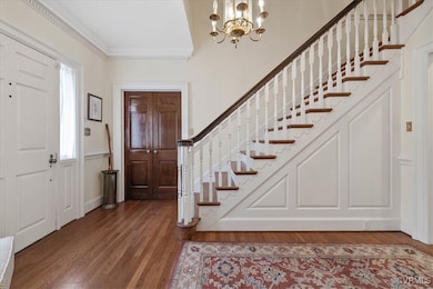 Foyer entrance showcasing the staircase and closed