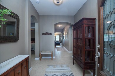 Arched doorways lead to secondary bedrooms and bat