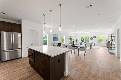 Kitchen with dark brown cabinetry, appliances wit