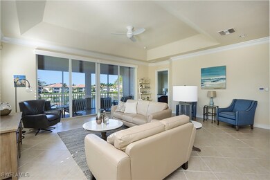 Tiled living room featuring crown molding, a raise
