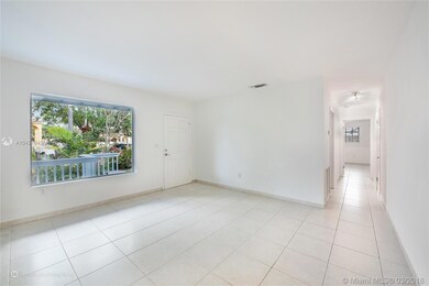 LIVING AND ENTRANCE WITH IMPACT WINDOW AND HALLWAY TO  MASTER AND 2ND BEDROOM