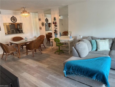 Living room with wood finished floors and a textured ceiling