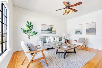 Living area featuring light wood finished floors and a ceiling fan