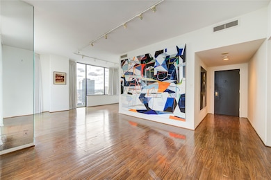 Tall ceilings, floor-to-ceiling windows, and integrated running lights create a bright, open atmosphere—amplified by a mirror that enhances the sense of space. (painting is not a mural, it's removable )