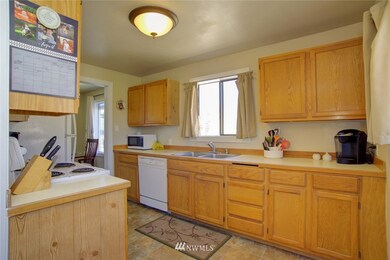 Updated kitchen with wood cabinetry, vinyl flooring and new refrigerator.