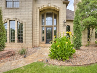 View of exterior entry with brick siding and roof with shingles