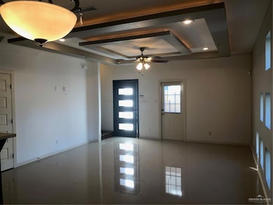 Entrance foyer with baseboards, recessed lighting, a raised ceiling, a ceiling fan, and light tile patterned floors
