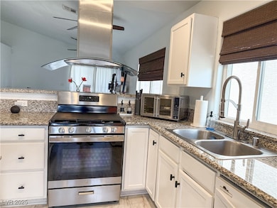 Kitchen featuring island range hood, visible vents