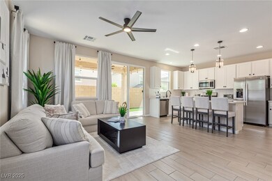 Living area with visible vents, light wood-style f