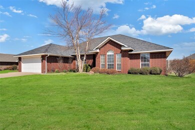 Ranch-style home with a garage and a front lawn