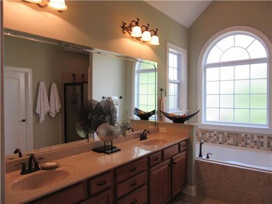 Master bath features double vanities and whirlpool tub