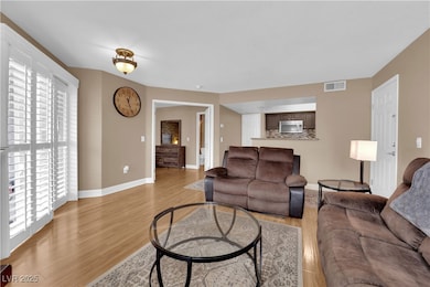 Living area featuring light wood finished floors a