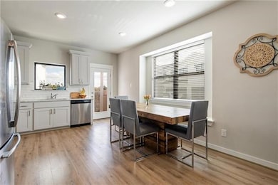 Dining area with recessed lighting, light wood-st