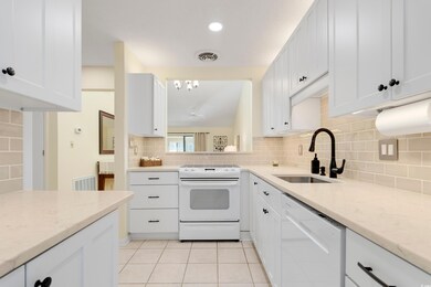 Kitchen with white cabinets, decorative backsplash