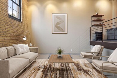 The sunken living room is accented with a stunning brick wall with large windows for natural light. * Virtually staged photography of the living room.