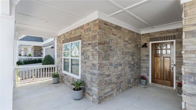 Property entrance featuring stone siding and a por